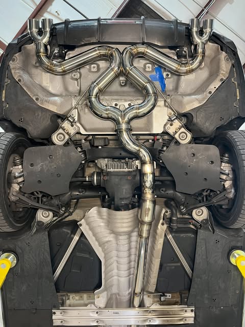 Custom stainless steel exhaust beneath a vehicle